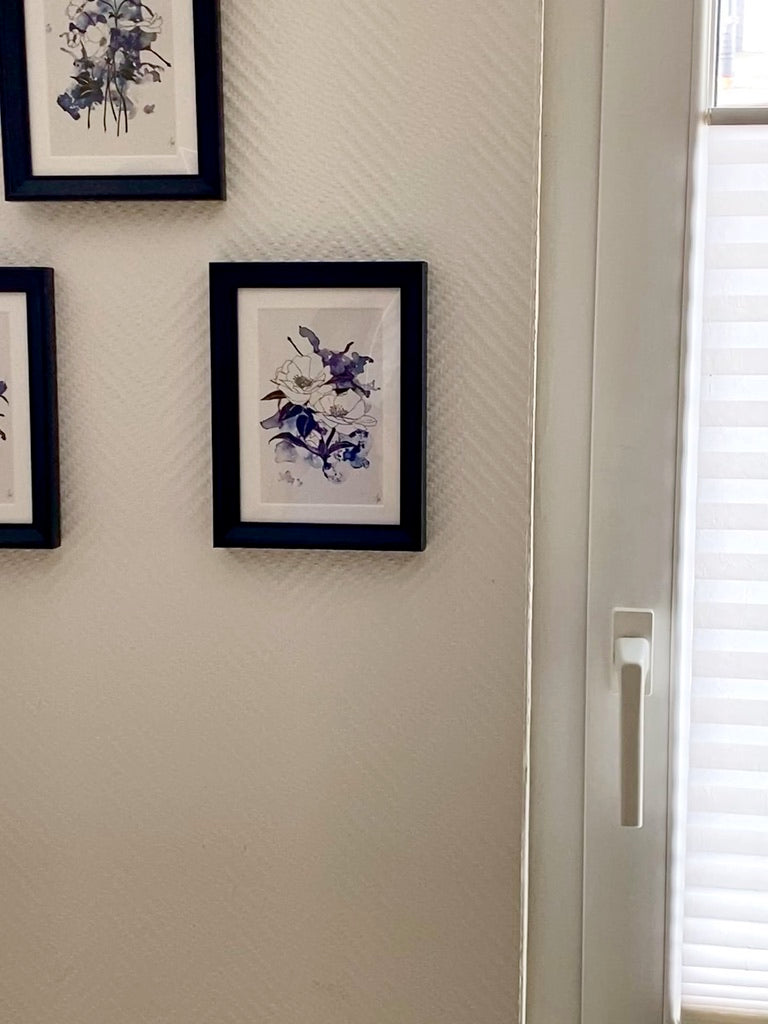 drei Bilder an der Wand hängend im schwarzen Rahmen mit Passepartout